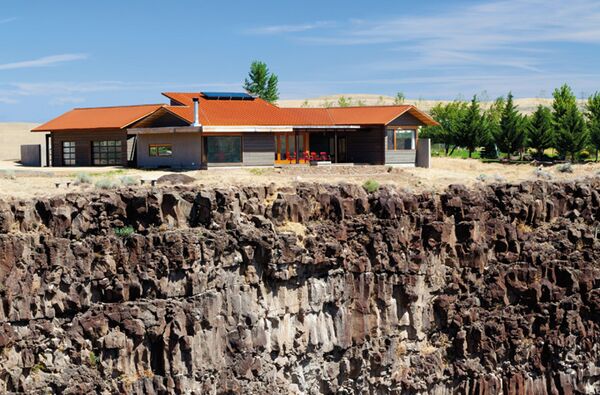 The home's low-slung exterior, natural-colored stucco and orientation away from the street give it an organic connection to the landscape. “The main design criteria was coming up with something that would work with the view,” says Mary Ellen.