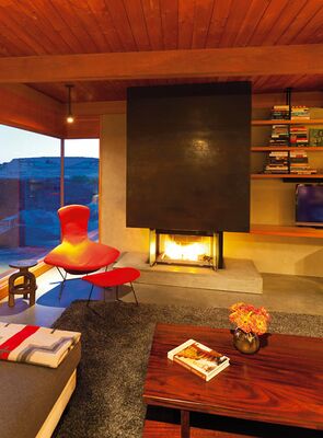 The propane fireplace's cold-rolled steel mantel provides the room's focal point. “The fire is actually nice and warm,” says Wilf. “You can just switch it on and enjoy it. This is another space where we like to spend the evening.”